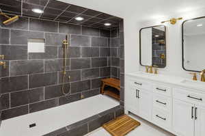 Full bath featuring double vanity, a walk in shower, and recessed lighting