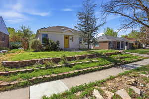 View of front facade featuring brick siding and a front yard