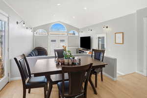Dining room with french doors, vaulted ceiling, light wood finished floors, and recessed lighting