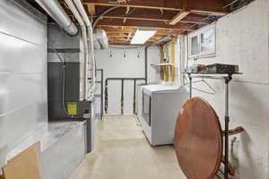 Laundry area with concrete floors and washing machine and dryer