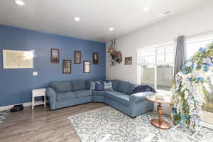 Living area featuring wood finished floors and recessed lighting