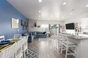 Living room with dark wood-style floors and recessed lighting