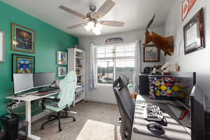 Office space with a ceiling fan and light carpet or can be another bedroom