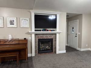 Living room with a fireplace and baseboards