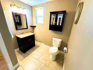 Bathroom featuring updated vanity, plumbing fixtures, and tile flooring.