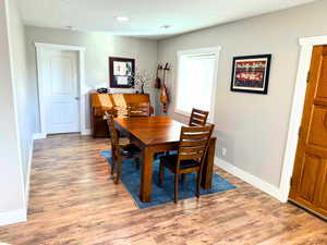 Dining room with updated flooring, base, trim, and interior doors.