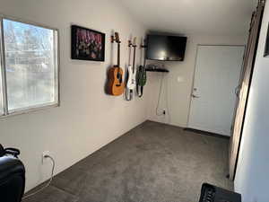 Interior space featuring light colored carpet and a barn door