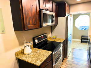 Granite countertops, updated cabinets, stainless steel appliances, updated plumbing fixtures, and wood flooring.