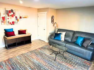 Living room, with updated wood flooring, recessed lighting, and updated finish work.
