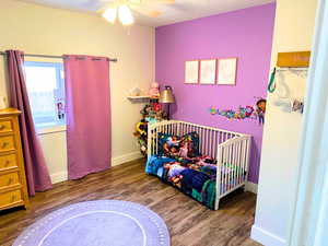 Bedroom featuring updated wood flooring, new base, and closet doors.