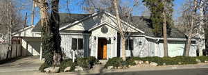 View of front of property with an attached garage, New roof (2023) and board and batten siding.