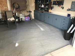 Garage with concrete block wall and a workshop area