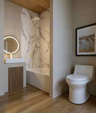 Bathroom with vanity, light wood finished floors, a freestanding tub, and wood ceiling