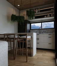 Dining room featuring wooden ceiling, light wood-type flooring, and a mountain view