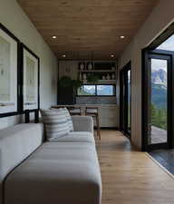 Living room with wood ceiling, light wood-style flooring, recessed lighting, and a mountain view