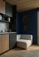 Bar with modern cabinets, wood ceiling, light countertops, and brown cabinetry