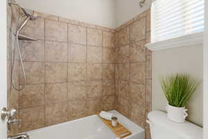 Full bathroom featuring shower / bathtub combination and toilet
