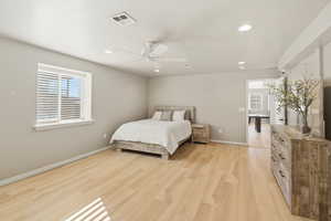 Bedroom featuring light wood finished floors, a ceiling fan, multiple windows, and recessed lighting