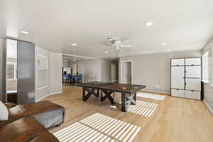 Game room with light wood-style floors, ceiling fan, and recessed lighting