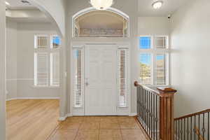 Foyer with tile patterned floors and arched walkways