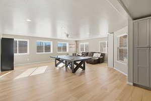Rec room with light wood-style flooring, recessed lighting, and ceiling fan