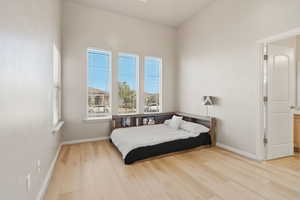 Bedroom featuring light wood-style flooring and baseboards