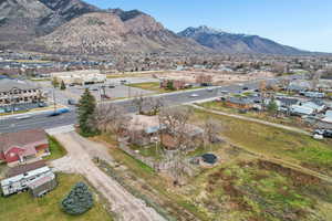 Aerial view of property and surrounding area with mountains and nearby suburban area