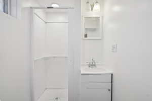 Bathroom featuring a stall shower and vanity