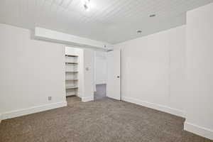 Unfurnished bedroom featuring carpet flooring and baseboards
