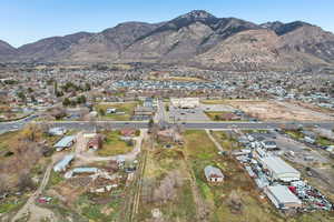 Aerial view of property's location featuring mountains and nearby suburban area