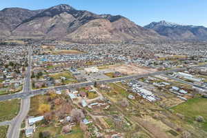 Aerial overview of property's location with mountains and nearby suburban area