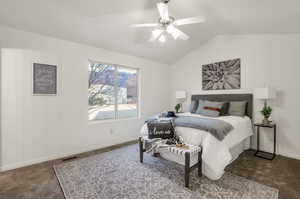 Bedroom featuring ceiling fan, lofted ceiling, and carpet