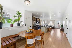 Dining space with light wood-style flooring and recessed lighting