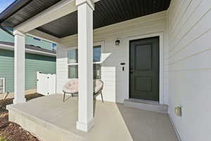 Doorway to property featuring a porch