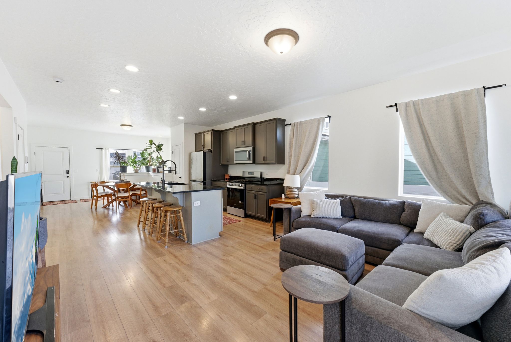 Living room with light wood finished floors and recessed lighting