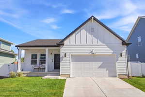 White siding exterior with black trim accents and a dark roof