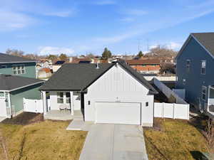 View of front of house featuring board and batten siding, a fenced backyard, a porch, and a residential view