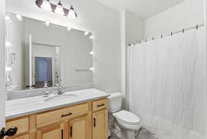 Full bath featuring vanity and curtained shower