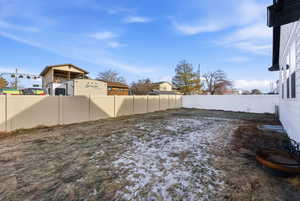 Fenced backyard with a residential view