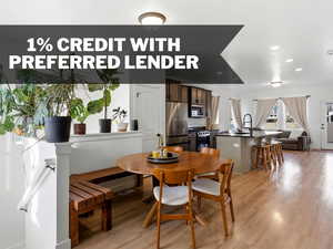 Dining space with light wood-style floors and recessed lighting