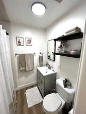 Bathroom featuring vanity, dark wood-type flooring, and a shower with shower curtain