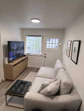 Living area with wood finished floors and baseboards