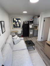 Living room with light wood-style flooring