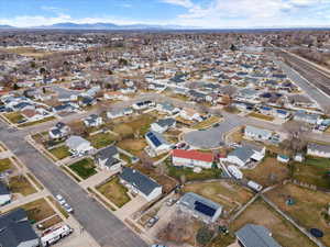 Aerial overview of property's location with nearby suburban area and a mountain backdrop