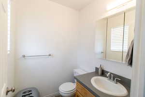 Half bath with vanity and toilet