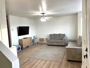 Living room with wood finished floors and ceiling fan