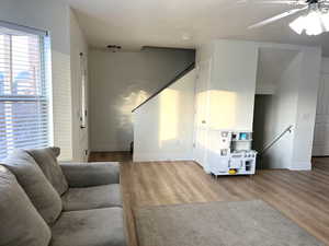 Living area with wood finished floors and a ceiling fan