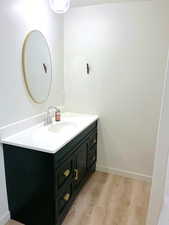 Bathroom with vanity and light wood finished floors