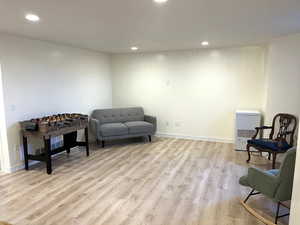 Sitting room featuring light wood-style floors and recessed lighting