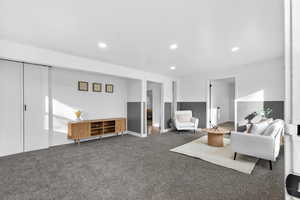 Carpeted living room featuring recessed lighting